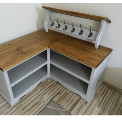 Grey corner bench with a wooden top and hooks above for hanging items.